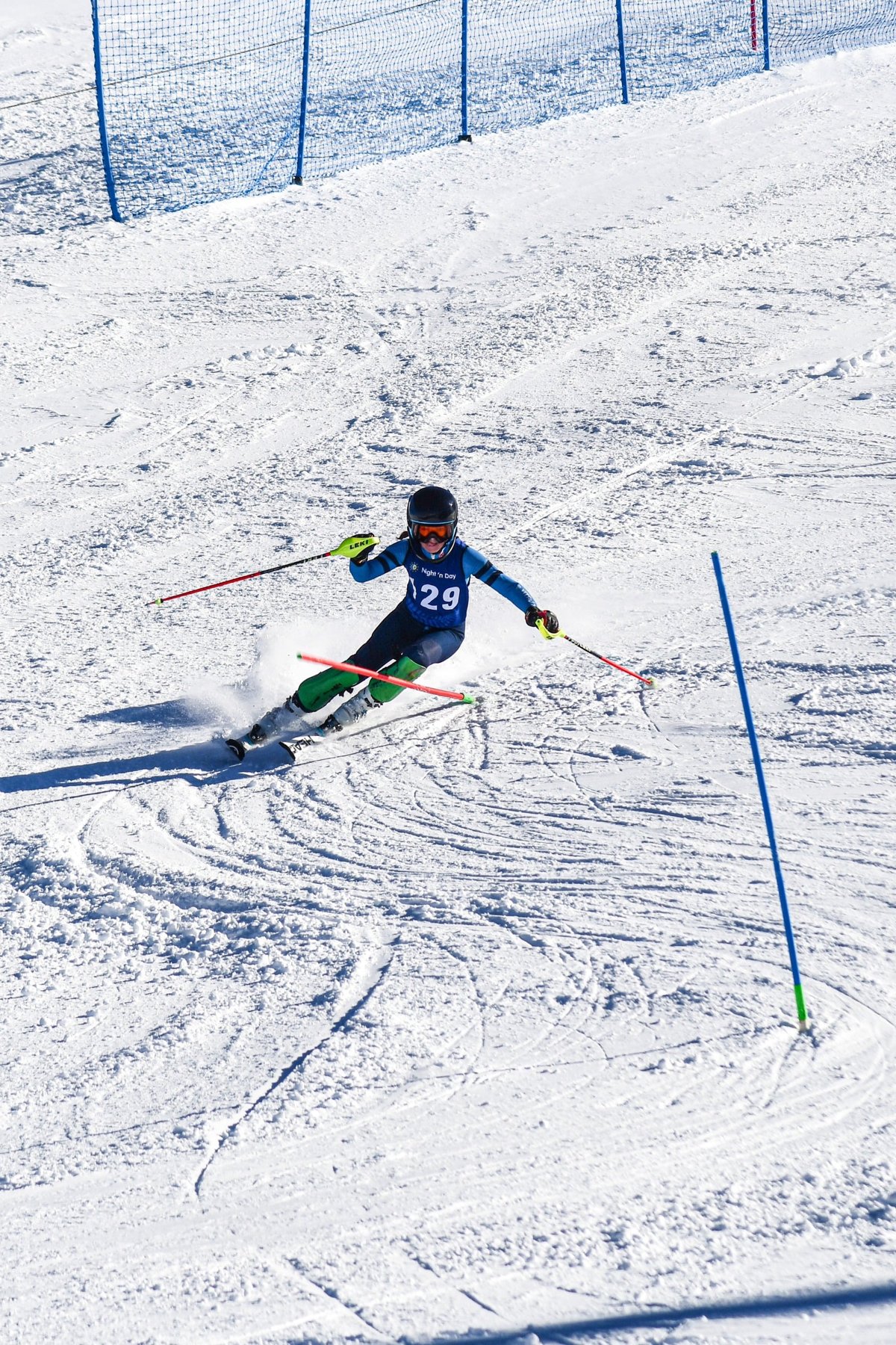 Lottie carving a turn through a ski race course